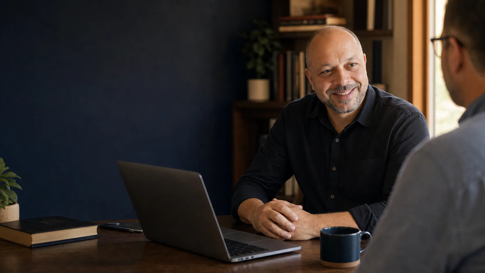 Patrick Bianconi working with a ministry leader in a warm studio office.